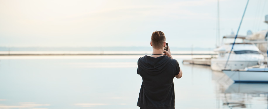 storage/images/posts//sea-takes-your-breath-awat-back-view-shot-stylish-young-european-guy-trendy-clothes-standing-seashore-taking-photo-sea-beautiful-yacht-smartphone-being-photojournalist-amateur1_1701386476.jpg